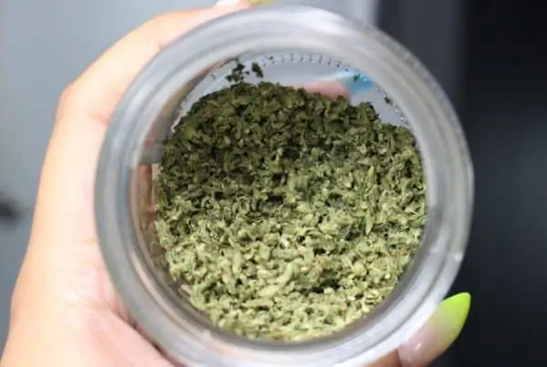 How to Legally Transport Cannabis in Colorado. Weed in glass jar.