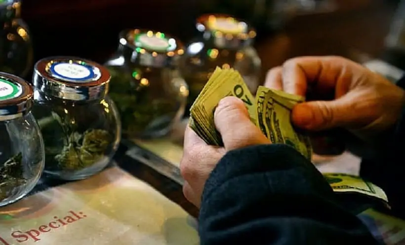 How to Market and Advertise a Marijuana Business. Man with cash in hand.