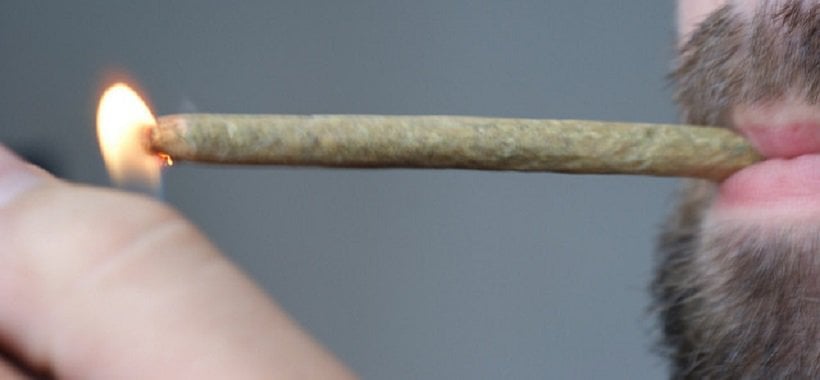 How to Roll a Marijuana Joint 1 How to Roll a Weed Joint. Man lighting a joint.