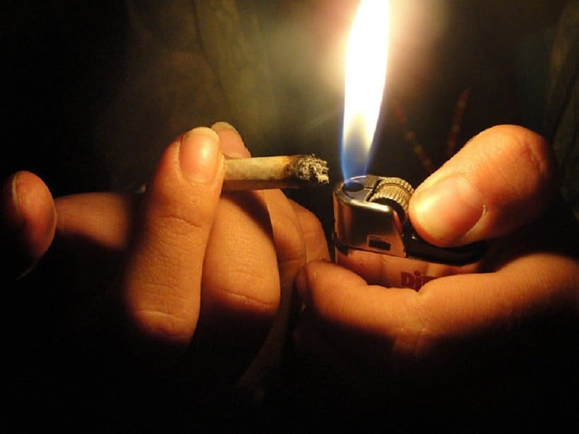 How to Smoke Marijuana to Get the Best Feeling. Hands lighting a joint.