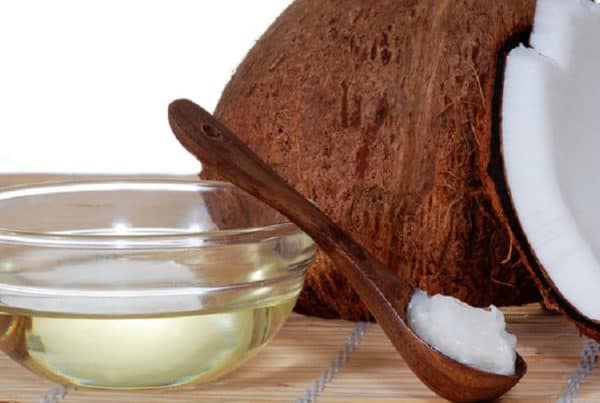 How Do You Make Weed Coconut Oil. Glass bowl of oil and a coconut.