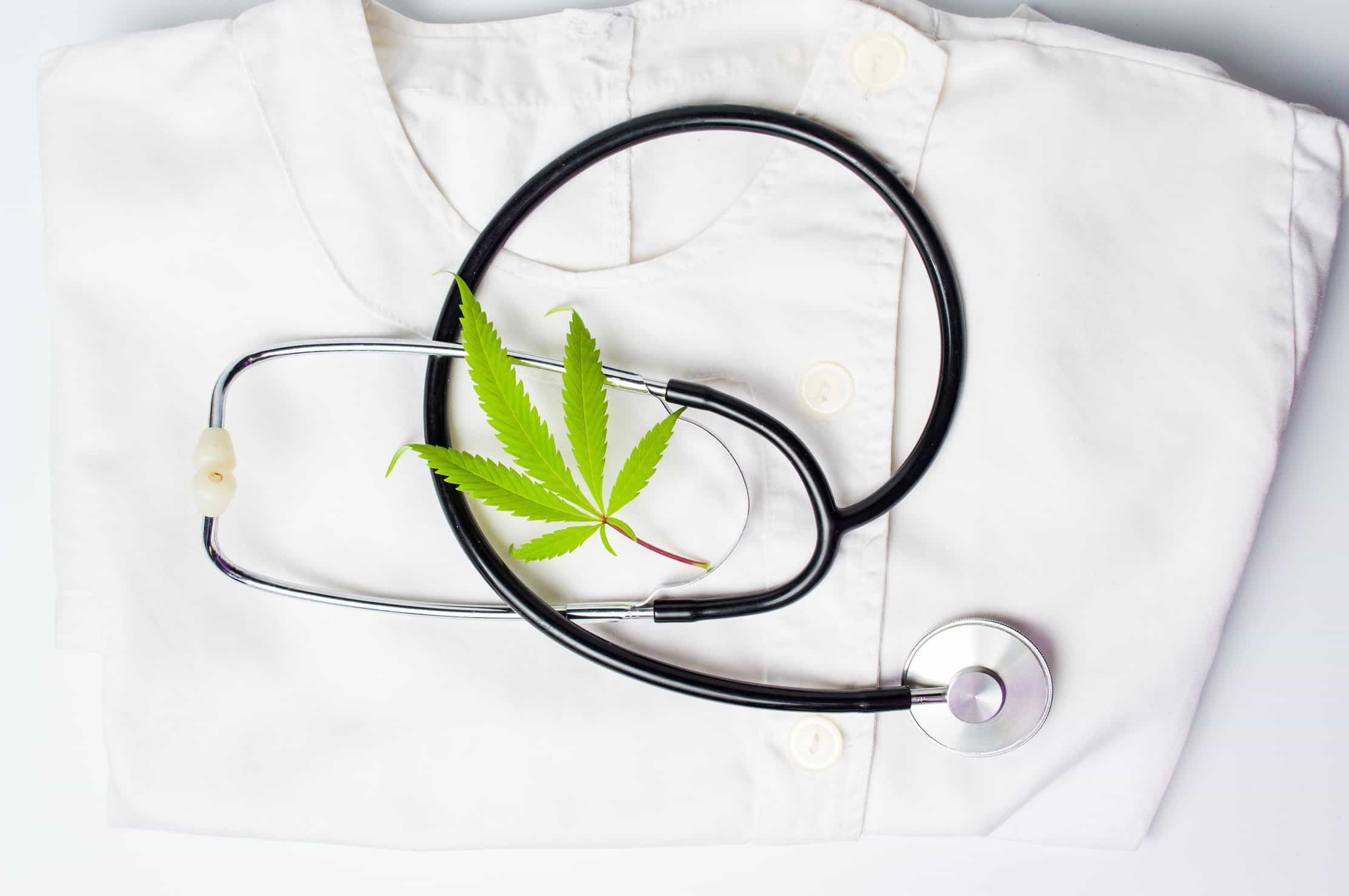 How to Become A Nurse In The Marijuana Industry. Stethoscope on scrubs with weed leave. 