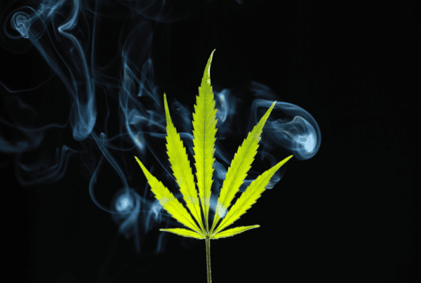 How Some Marijuana Users Discreetly Smoke In Hotels. Green marijuana leaf with smoke around it.