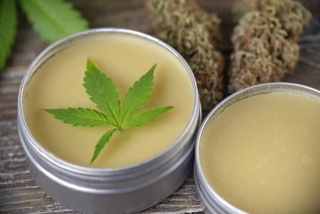 Tips On Creating Marijuana Topical Products. Topical in a container with a marijuana leaf.