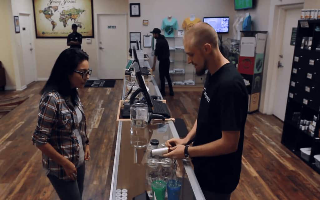 How to Launch A Marijuana Business. Dispensary worker and customer.