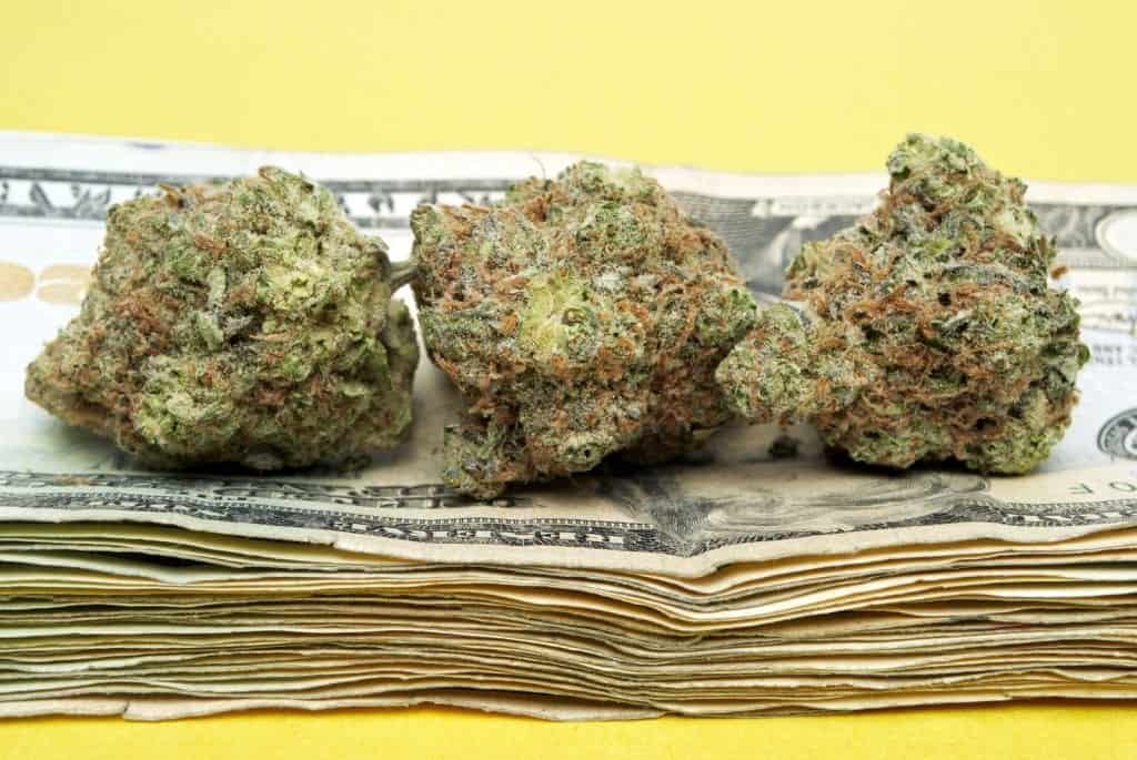 Learn More about the Best-Selling Marijuana Strains. Marijuana buds on top a stack of money.