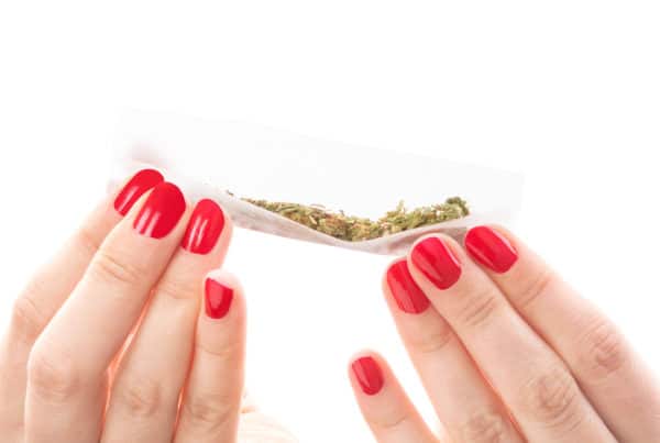 Female Marijuana Influencers Who Have Impacted The Industry. Two hands holding a joint