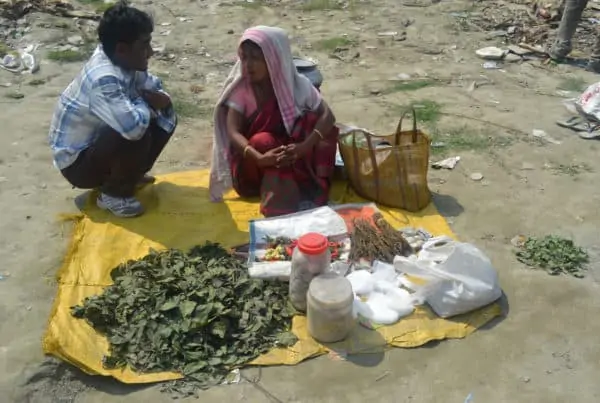 What exactly is bhang? Two people on a blanket with leaves.