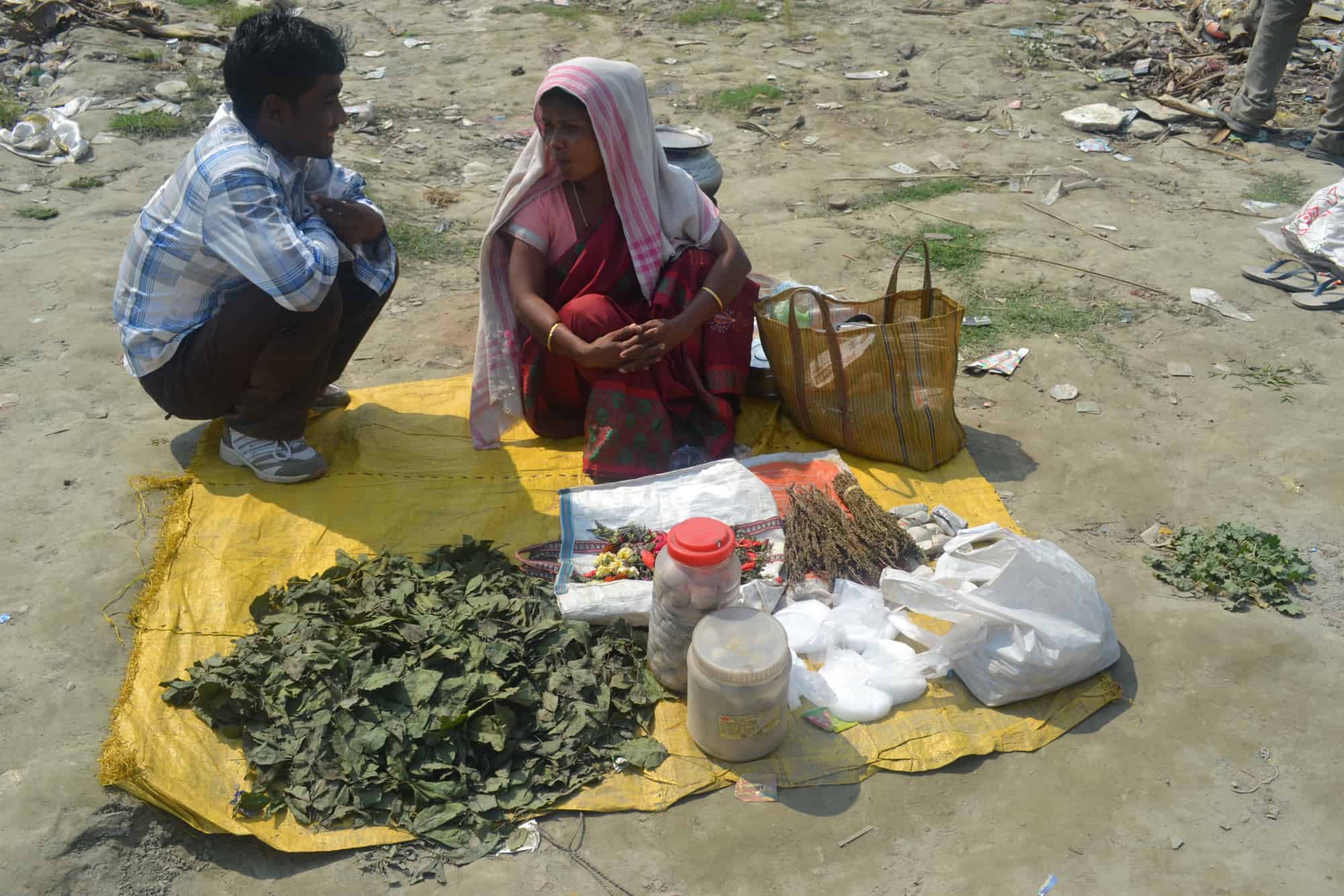 What exactly is bhang? Two people on a blanket with leaves.