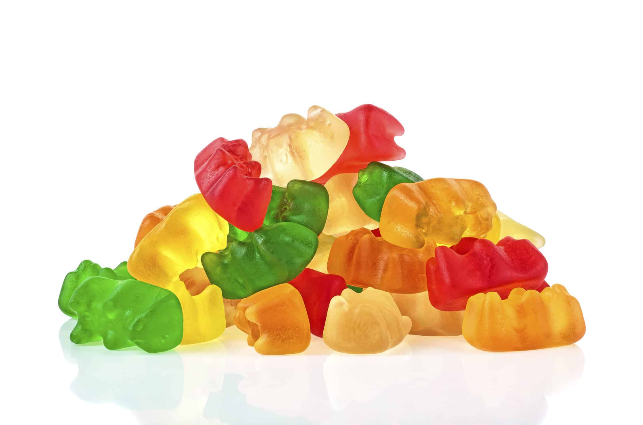 A pile of CBD gummies on a white surface.
