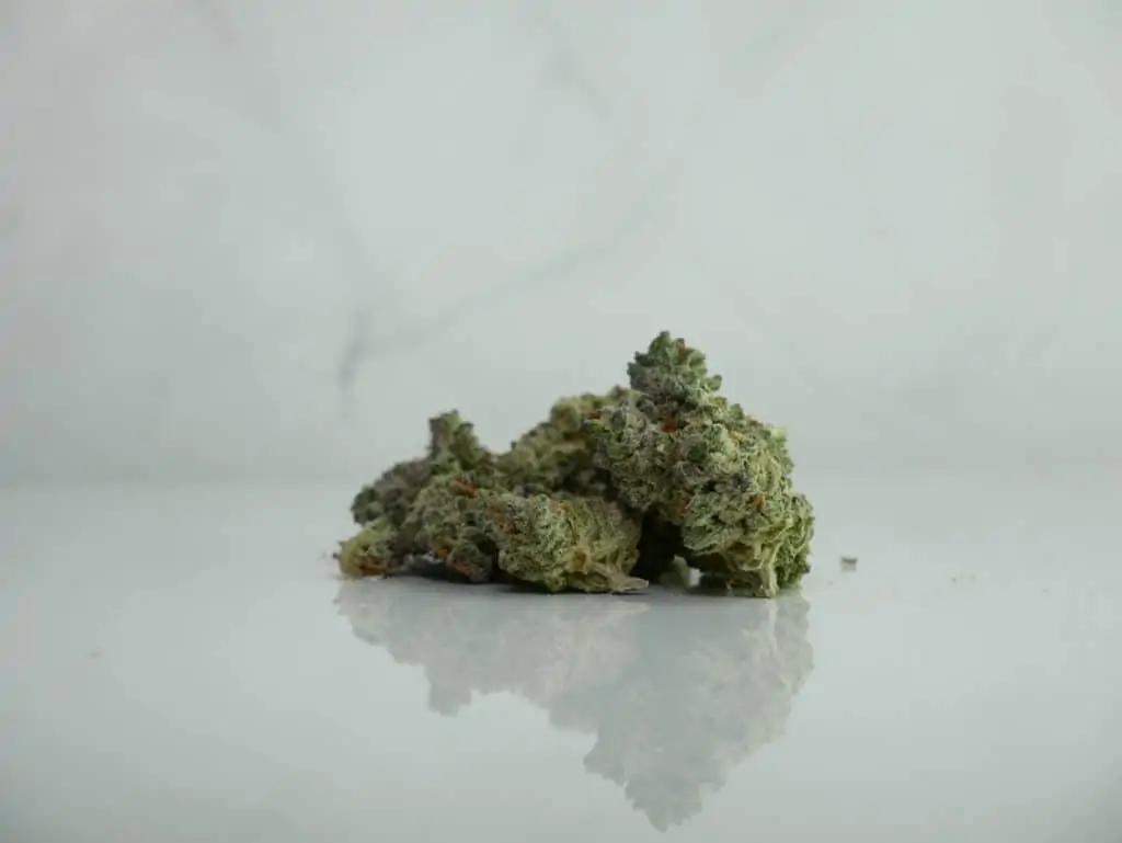Best indica strain for sleep on white surface with a marble background.
