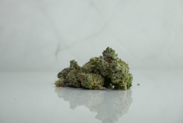 Best indica strain for sleep on white surface with a marble background.