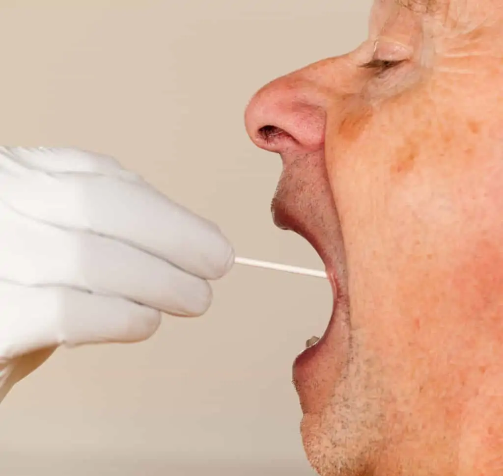 Man getting his mouth swab for a drug test