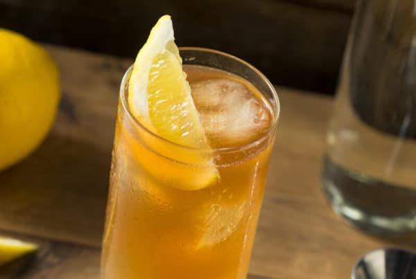 jeremiah weed peach sweet tea vodka in a glass with a lemon