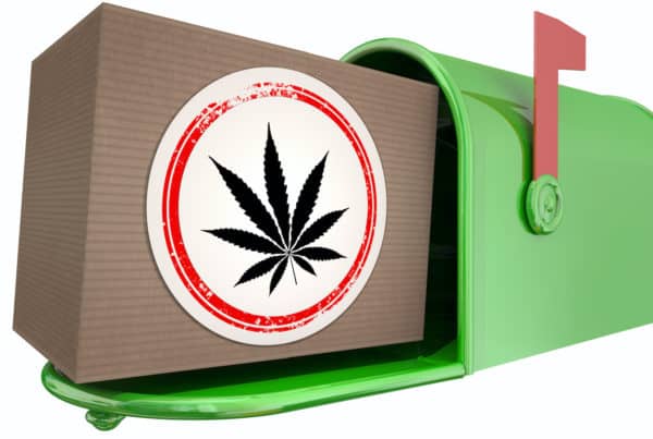 cardboard box with weed sticker in a mailbox, can you mail weed