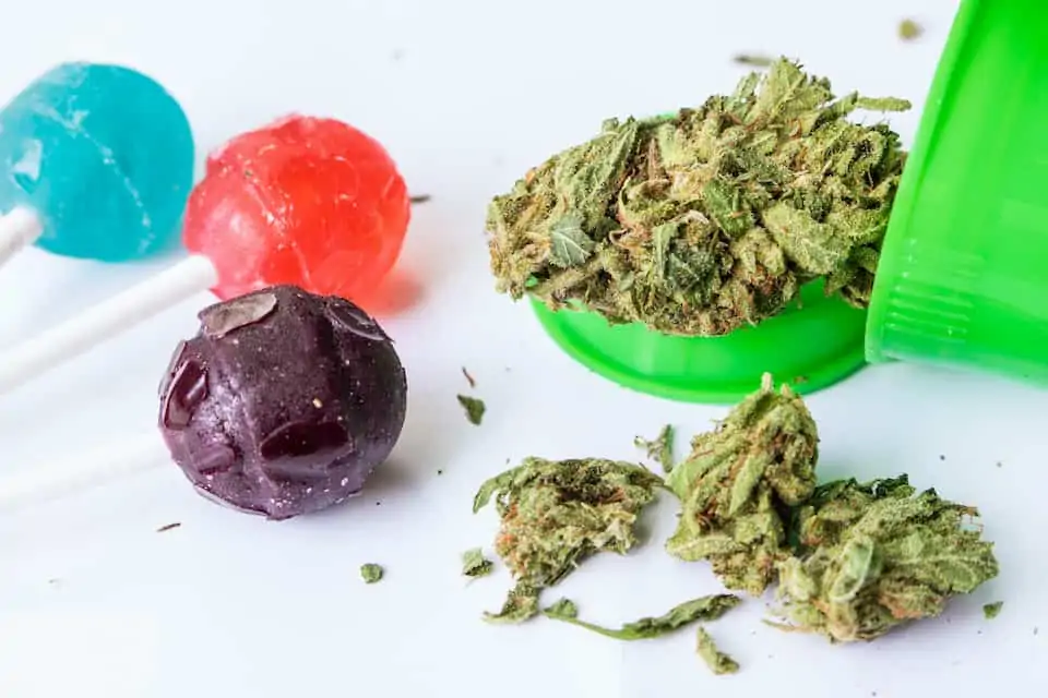 How to Make THC Candy 1 weed in green bowl next to colorful suckers, how to make THC candy