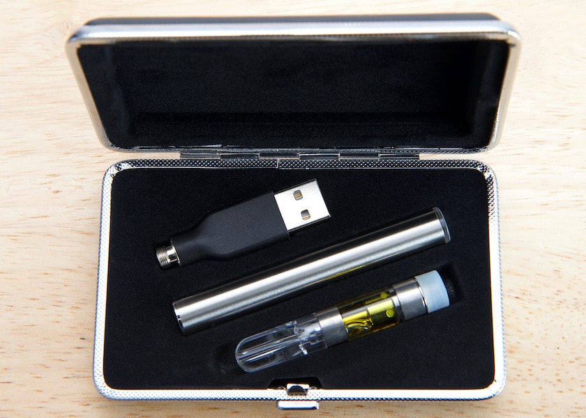 Vaping pen with oil in a velvet case, best wax pen