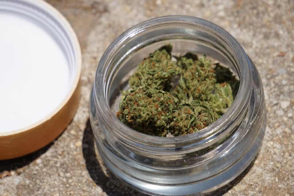 marijuana bud in glass container, how to work at a weed dispensary