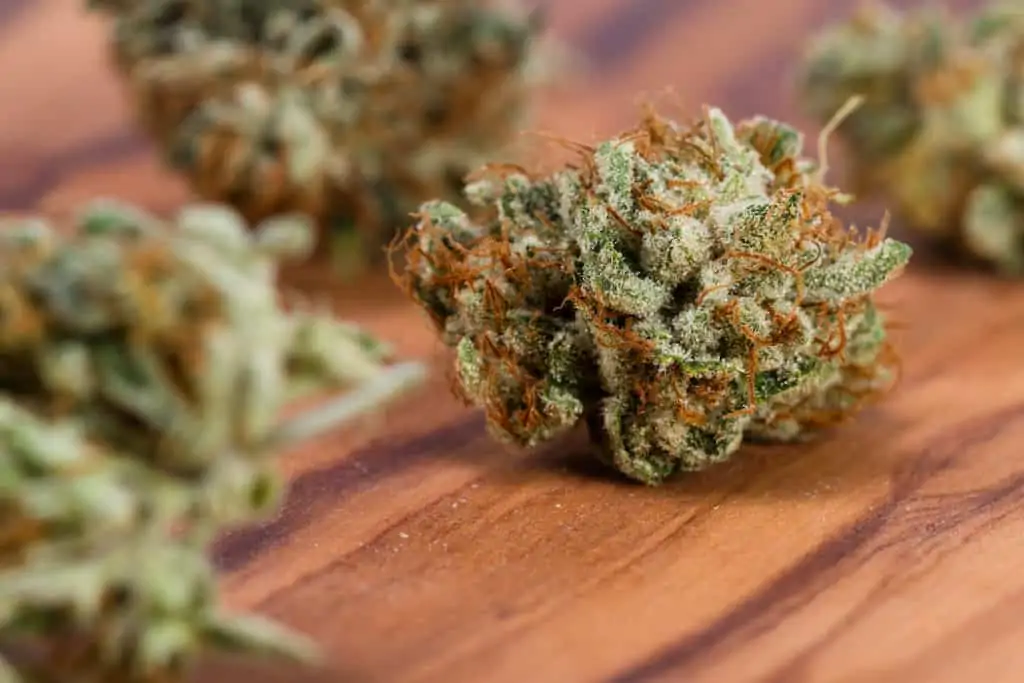 Diamond Cookies Strain Review 1 marijuana buds on wood table, diamond cookies strain