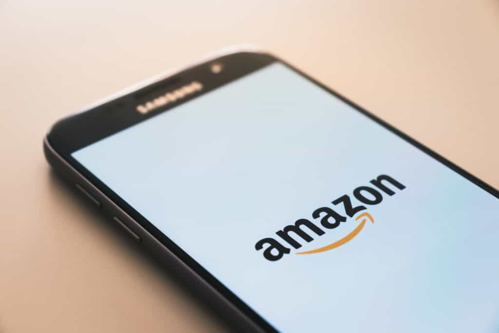 Amazon Supports Legal Cannabis, Drops Drug Screening 1 cellphone with amazon app on it, amazon supports legal cannabis