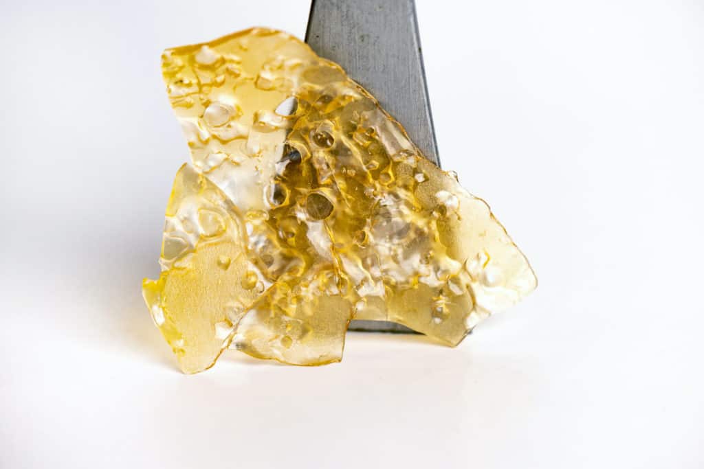 Celebrate 710 Day: Guide to Cannabis Extracts And Concentrates 1 cannabis shatter isolated on white, cannabis extracts and concentrates