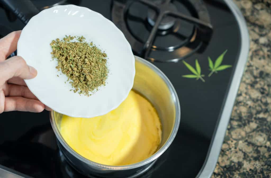 Mixing crushed cannabis with melted butter to prepare marijuana butter, marijuana butter recipe