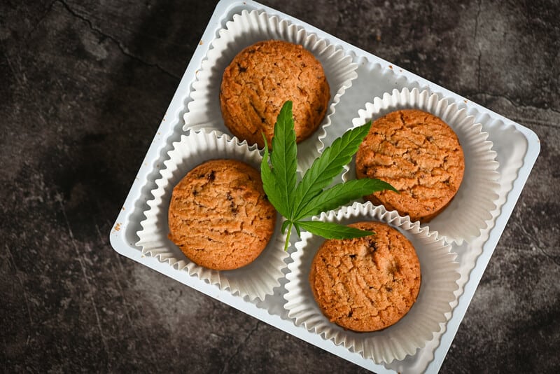 cookies in a tray with a cannabis leaf on top, sativa vs indica edibles