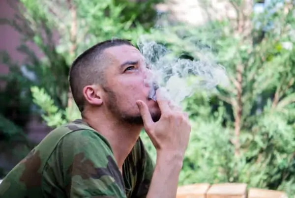 Young Man Sitting In the Backyard smoking, veterans and cannabis