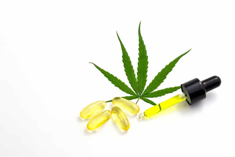 cbd liquid with weed leaf isolated on white 