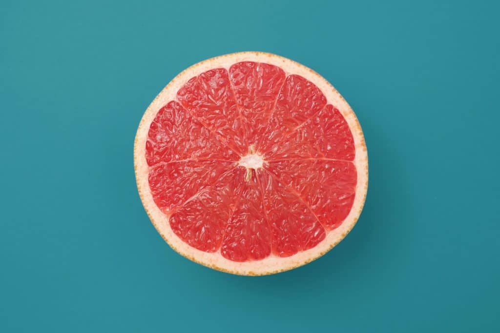 sliced grapefruit half on blue