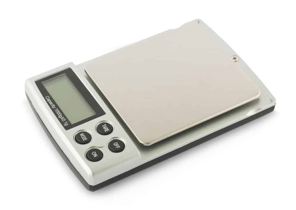 scale isolated on white, how many ounces in a pound