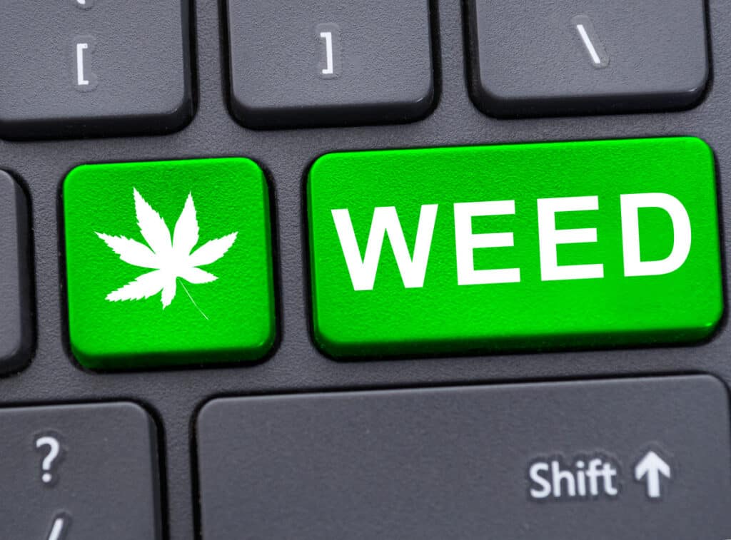 cannabis consumers searching online for weed. keyboard with weed written on it and a weed leaf