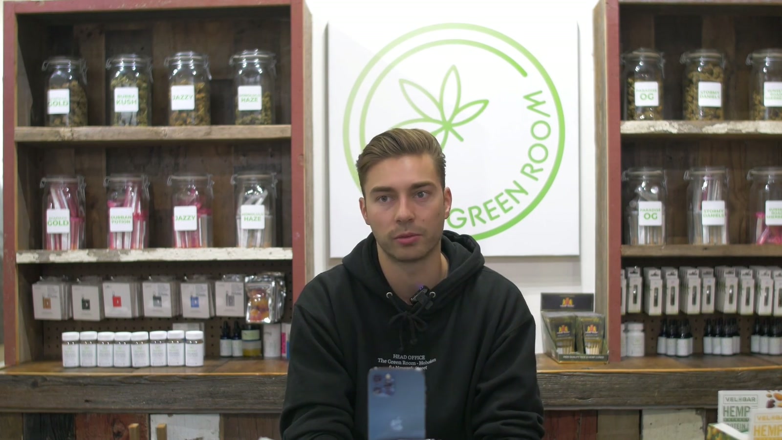 Darek Wajda, founder of The Green Room, interviewed in his hemp-CBD store in New Jersey in front of shelves of CBD products